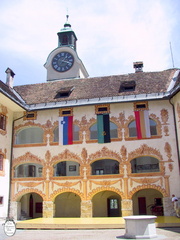 Idrija town castle courtyard with flags
