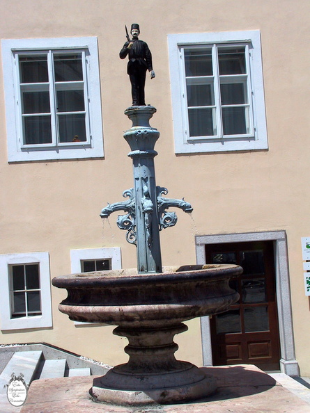 Idrija town fountain with miner statue
